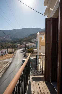 a balcony of a house with a view of a street at Villa Elizabeth in Symi