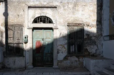 an old building with two doors on a street at Villa Elizabeth in Symi