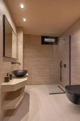 a bathroom with a sink and a glass shower at Olympus Luxury Villa Rhodes in Koskinou
