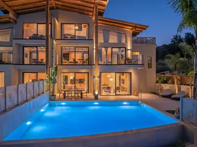 a house with a swimming pool in front of it at Olympus Luxury Villa Rhodes in Koskinou