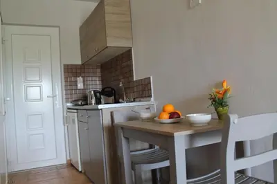 a small kitchen with a table with oranges on it at Melody Studios Faliraki in Faliraki