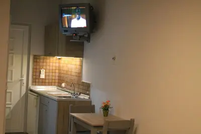 a kitchen with a tv hanging on the wall at Melody Studios Faliraki in Faliraki