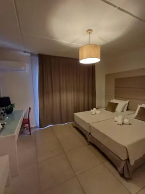 a bedroom with a large bed and a light at Atlantis Boutique ΑΝΝΕX in Rhodes Town