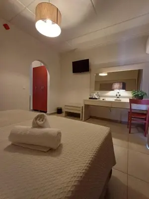 a bedroom with a bed and a kitchen with a sink at Atlantis Boutique ΑΝΝΕX in Rhodes Town