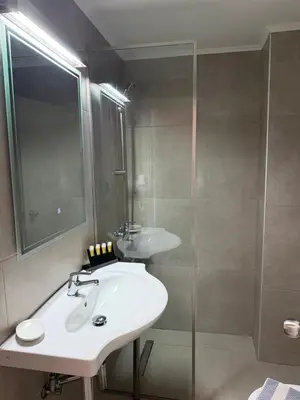 a bathroom with a sink and a shower at Atlantis Boutique ΑΝΝΕX in Rhodes Town