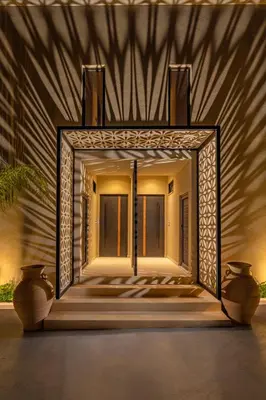 a mirror on the side of a building with two vases at Vadis Luxury Villa Rhodes in Koskinou