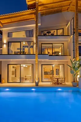 a house with a swimming pool in front of it at Vadis Luxury Villa Rhodes in Koskinou