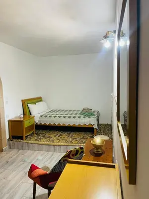 a room with a bed and a table and a table sidx sidx at Thomas house in Archangelos