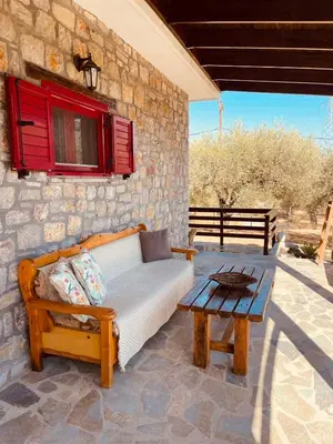 a couch and a table on a patio at Thomas house in Archangelos