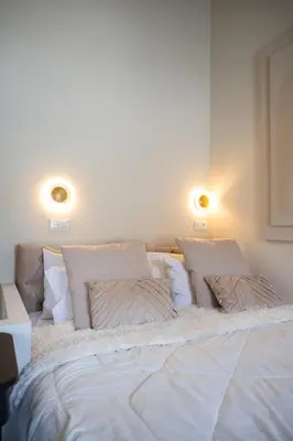a bed with white sheets and pillows in a room at Tinas Lindian Serenity Villa in Líndos