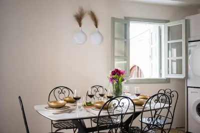 a dining room with a white table and chairs at Tinas Lindian Serenity Villa in Líndos