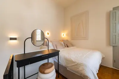 a bedroom with a bed and a vanity with a mirror at Tinas Lindian Serenity Villa in Líndos