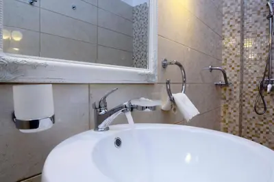 a bathroom with a white sink and a mirror at Villa Skiadeni in Halki