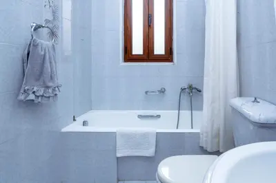 a bathroom with a tub and a toilet and a sink at Villa Skiadeni in Halki