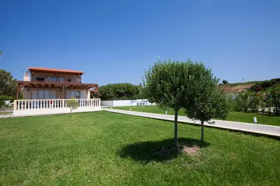 a house with a small tree in a yard at Villa Nefeli in Kiotari