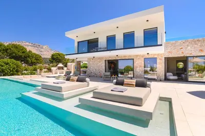 an image of a house with a swimming pool at Villa Pefkos Cove by Villa Plus in Pefki Rhodes