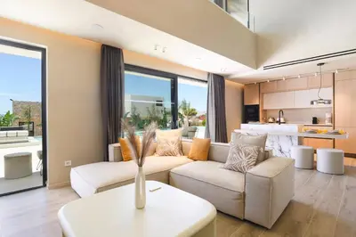 a living room with a couch and a table at Villa Pefkos Sunset by Villa Plus in Pefki Rhodes