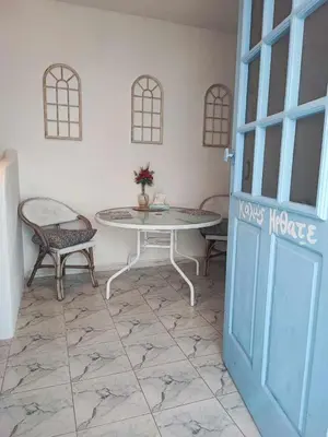 a room with a table and chairs and a door at Studio Lachania in Lachania