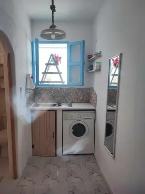 a laundry room with a washing machine and a window at Studio Lachania in Lachania