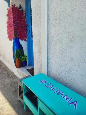 a blue bench sitting next to a vase of flowers at Studio Lachania in Lachania