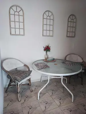 a table and two chairs with a vase on it at Studio Lachania in Lachania