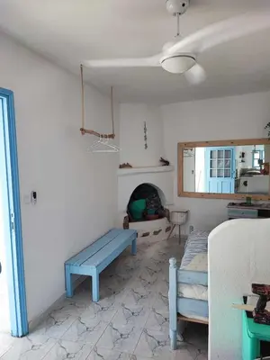 a living room with a blue bench and a fireplace at Studio Lachania in Lachania