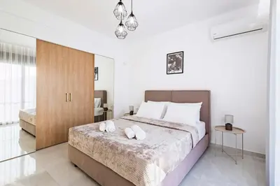a bedroom with a bed with two white towels on it at Ramo Luxury Villa in Kremasti