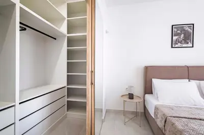 a bedroom with a bed and a closet at Ramo Luxury Villa in Kremasti