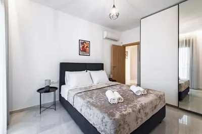 a bedroom with a bed with two towels on it at Ramo Luxury Villa in Kremasti