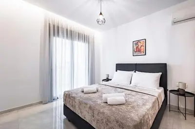a bedroom with a large bed with two towels on it at Ramo Luxury Villa in Kremasti