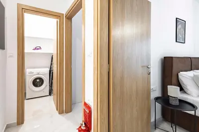 a room with a bed and a washing machine at Ramo Luxury Villa in Kremasti