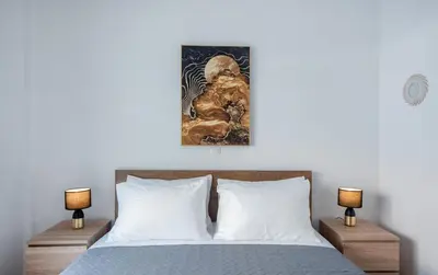 a bedroom with a bed with two lamps at Rhodes Center 2-Bedroom Apartment in Rhodes Town
