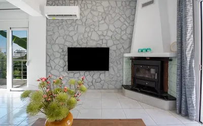 a living room with a fireplace and a tv at Rhodes Center 2-Bedroom Apartment in Rhodes Town