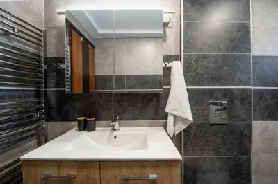a bathroom with a sink and a mirror at Rhodes Center 2-Bedroom Apartment in Rhodes Town
