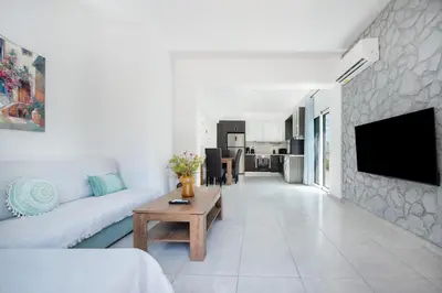a white living room with a couch and a table at Rhodes Center 2-Bedroom Apartment in Rhodes Town