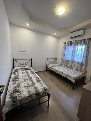 a bedroom with a bed and a couch and a window at Damian House in Afantou
