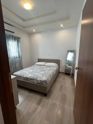 a bedroom with a bed and a mirror in it at Damian House in Afantou
