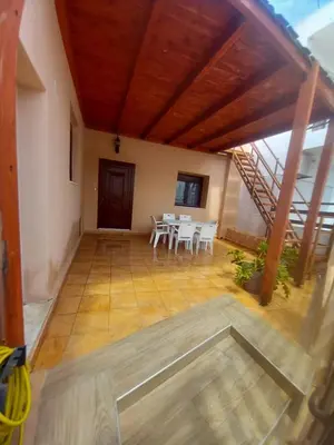 a room with a table and chairs and a staircase at Damian House in Afantou