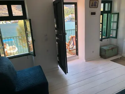 a living room with a view of the water at La DESIRADE in Symi
