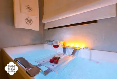 a table with a glass of wine and a glass of strawberries at Villa Panthea in Líndos