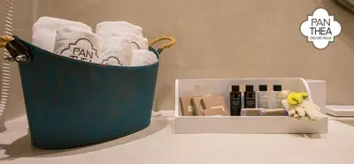 a blue bucket of towels and a box of cosmetics at Villa Panthea in Líndos