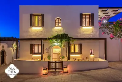 a house with a courtyard at night at Villa Panthea in Líndos