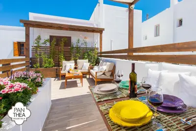 a patio with a table with glasses of wine at Villa Panthea in Líndos