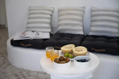 a white table with a tray of food and drinks at Aegean Nest in Koskinou