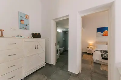 a bedroom with a white dresser and a bed at Aegean Nest in Koskinou