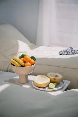 a bowl of fruit on a tray next to a bed at Aegean Nest in Koskinou