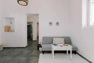 a living room with a couch and a table at Aegean Nest in Koskinou