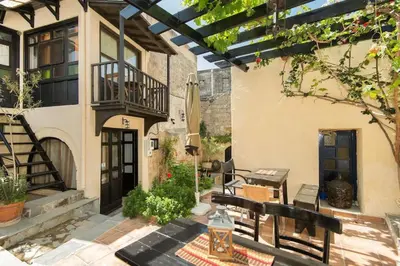 a patio with a bench and a building at Saint Michel Apartments in Rhodes Town