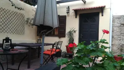 a patio with a table and an umbrella at Saint Michel Apartments in Rhodes Town