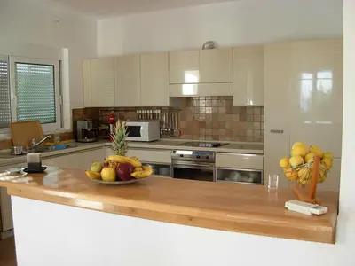 a kitchen with a bowl of fruit on a counter at Villa Chevalier in Kiotari